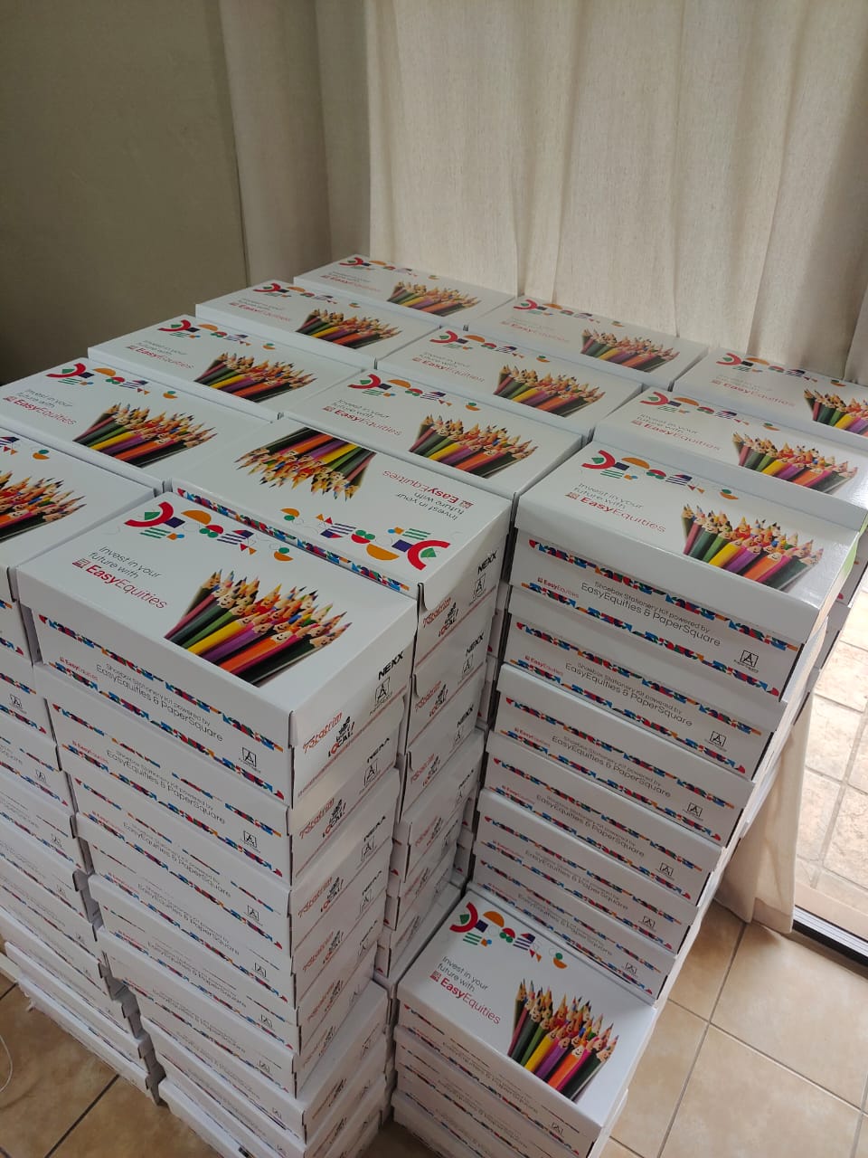 Stacks of PaperSquare stationery shoebox kits prepared for learners